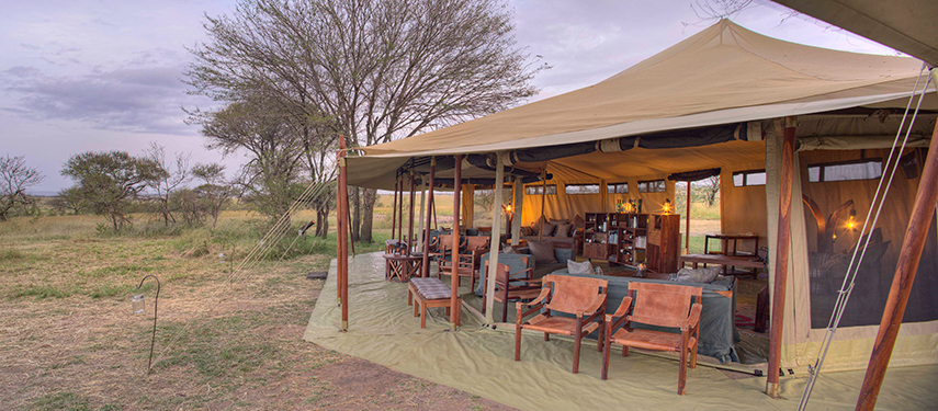 Open-sided lounge and dining area at Olakira Migration Camp overlooking the bush.