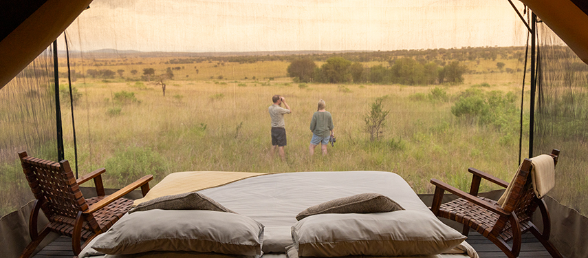 View from inside a stargazing tent at Olakira, with a bed facing the Serengeti plains.