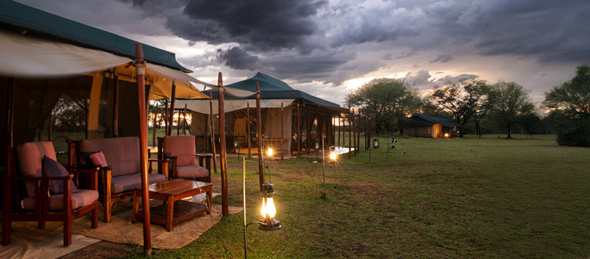 Serengeti Ndutu Kati Kati Tented Camp in the evening with oil lamps lighting private tents