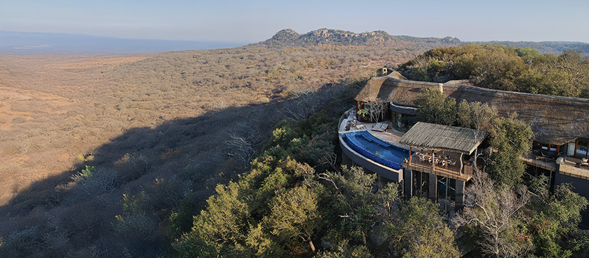 Aerial view of Malilangwe House on an escarpment overlooking a panoramic landscape