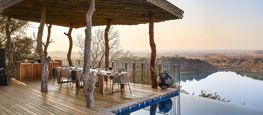 Stunning infinity pool and al fresco dining area at Singita Malilangwe House, Zimbabwe