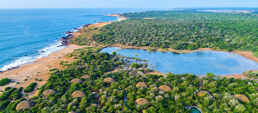 Aerial view of the lagoons and suites of Uga Chena Huts resort surrounded by jungle, Sri Lanka