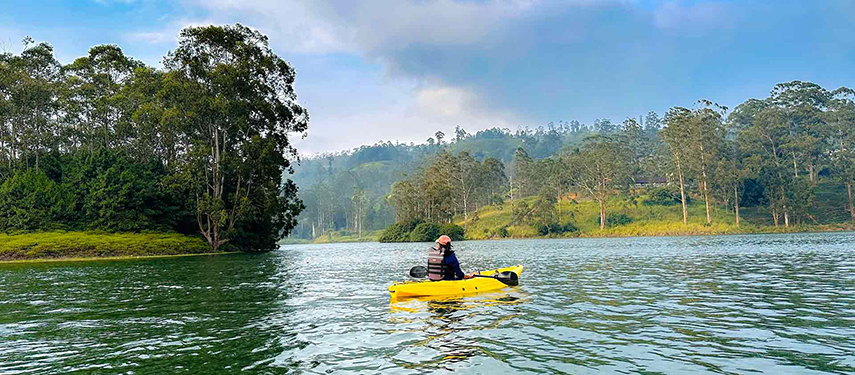 Woman kayaks on a lake in Sri Lanka
