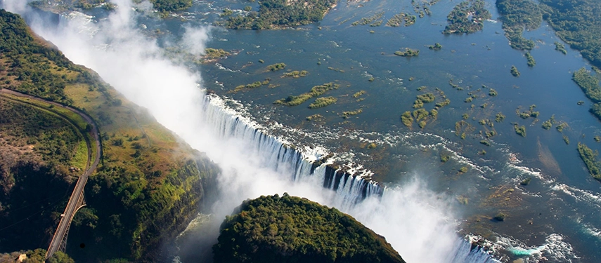 Aerial view of Victoria Falls with mist rising from the gorge near Insika Lodge.