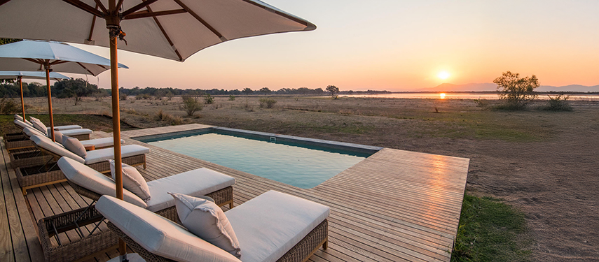 Chikwenya Camp swimming pool at sundown, Zimbabwe