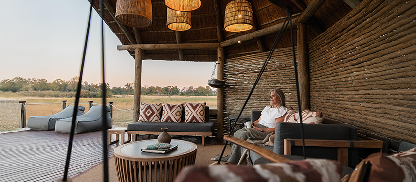 A woman enjoying the view of the Okavango Delta region from a luxury safari camp