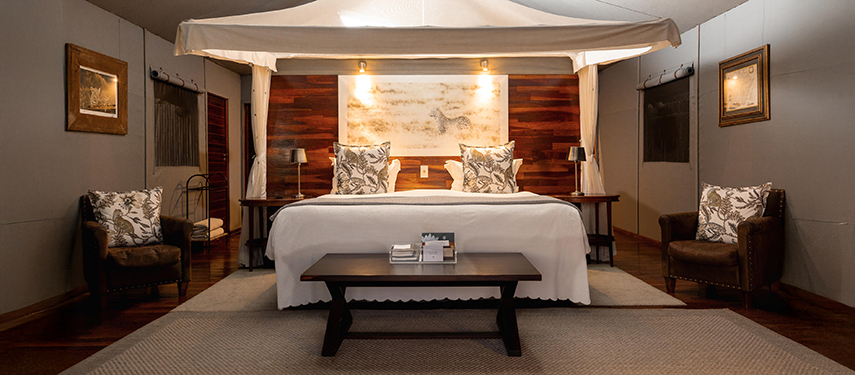 Luxurious bedroom tented suite at a safari camp in Botswana