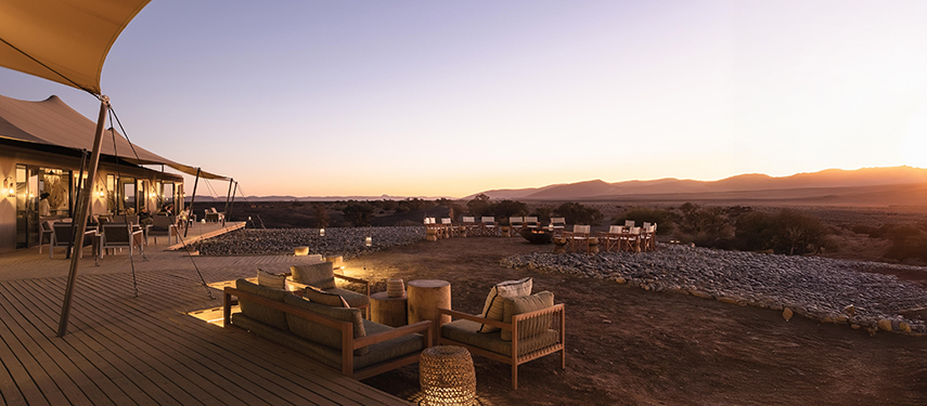 Kulala Desert Lodge outdoor lounge area overlooking Sossusvlei at sunset