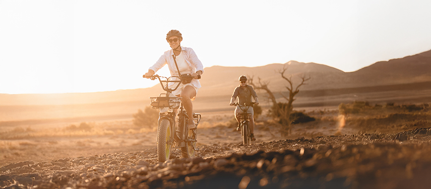 Tourists enjoy a cycle ride thro0ugh the Namibian desert