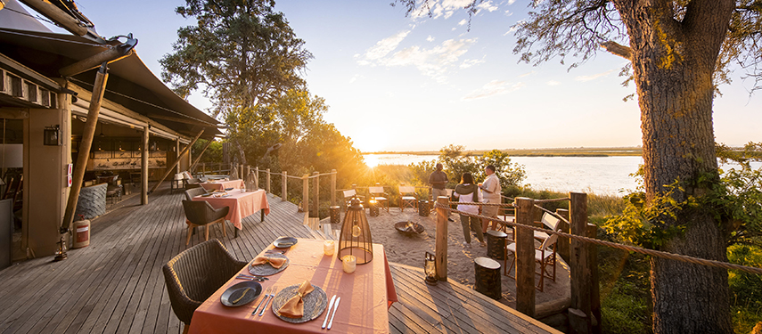 Guests enjoy breakfast on the dining deck of Little DumaTau tented safari camp