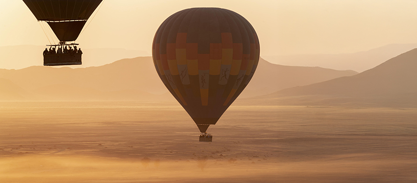 Hot-air balloons over the Namibian desert at sunrise