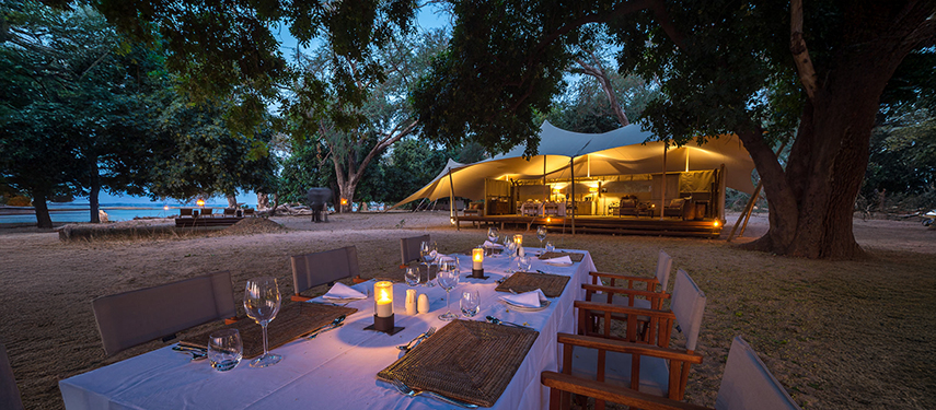 Elaborate al fresco dining area at Little Ruckomechi Camp, Zimbabwe