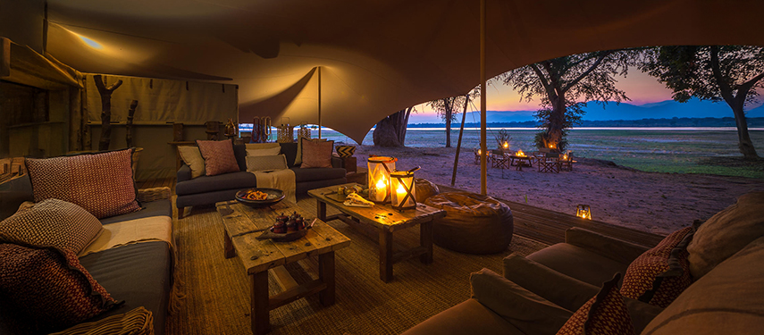 Colonial-style lounge area at night Little Ruckomechi Camp, Zimbabwe