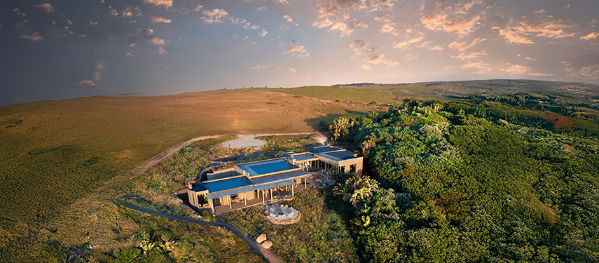 Aerial view of Gwegwe Beach Lodge surrounded by coastal forest and open plains.