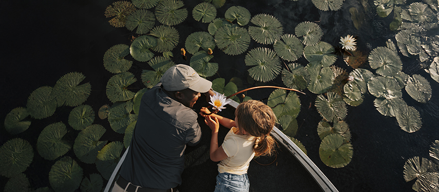 African safari guide teaches a young girl about the botany of the Okavango Delta