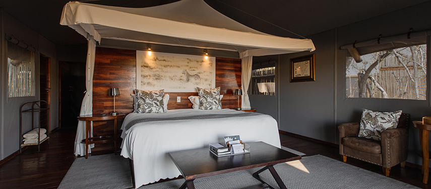 Luxurious bedroom tented suite at a safari camp in Botswana