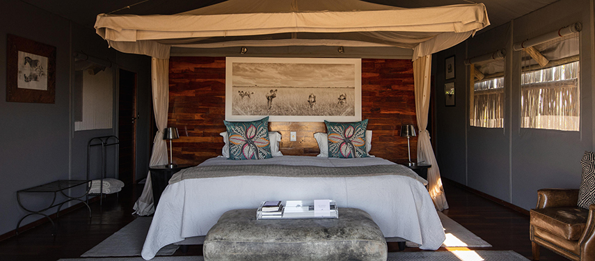 Luxurious bedroom tented suite at a safari camp in Botswana