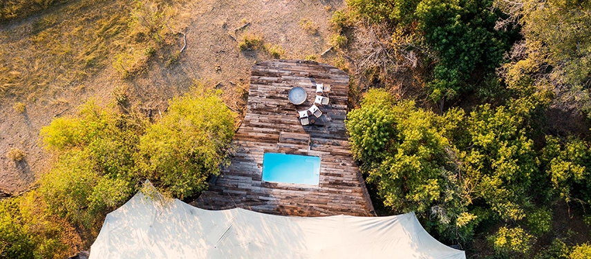 Aerial view of the Zarafa Dhow Suite in the Selinda Reserve, highlighting the private plunge pool, firepit and secluded position within the surrounding bush.