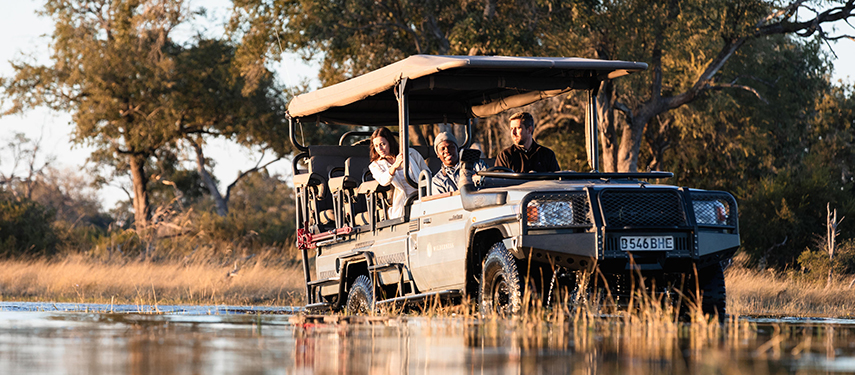 Guests enjoy a four-wheel drive game drive through Botswana's Okavango Delta