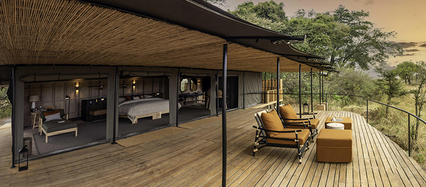 Expansive timber deck of a luxury tent at Kiri Camp offering views over the Okavango floodplains.