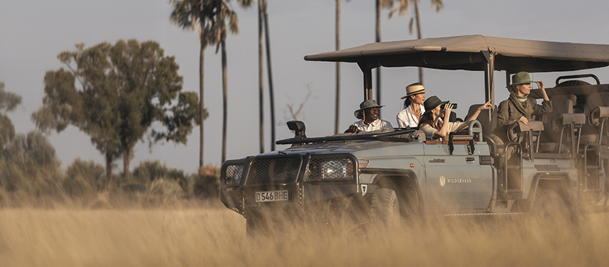 Guests on a game drive through Moremi Game Reserve Botswana