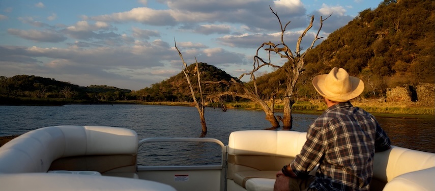 Tourist fishing on Malilangwe Dam, Zimbabwe
