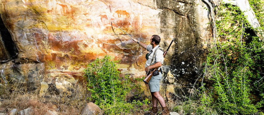 Guide points to ancient San rock artwork in Zimbabwe