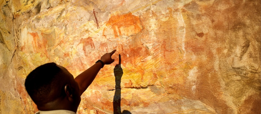 Guide points to ancient San rock artwork in Zimbabwe