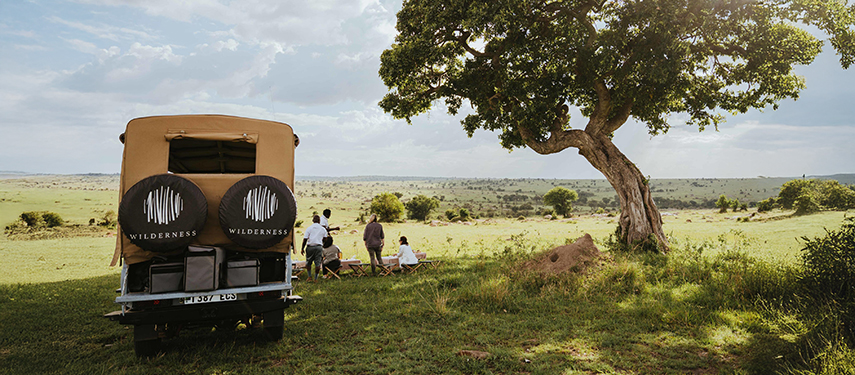 Guests have a picnic during a game drive in the Serengeti