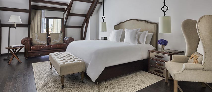 Elegant guest room at Four Seasons Casa Medina with wood-beamed ceilings and refined Colombian furnishings.