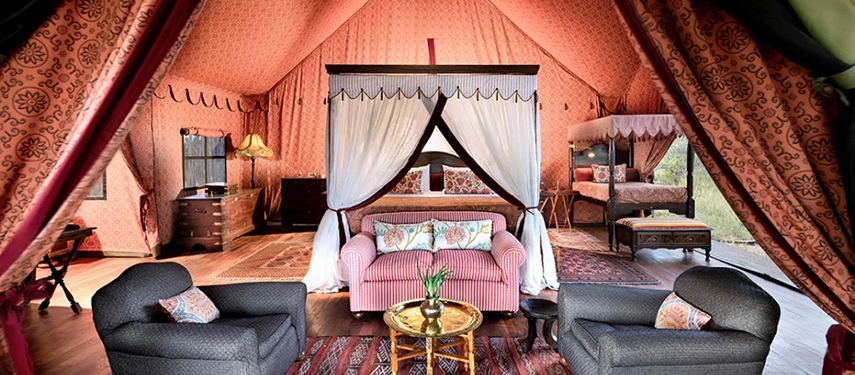 Luxurious tented suite at Jack’s Private Camp with classic safari furnishings and Persian rugs.