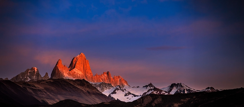 Mount Fitz Roy glowing crimson at sunrise above the Patagonian steppe, an iconic peak in Argentina’s Los Glaciares National Park.