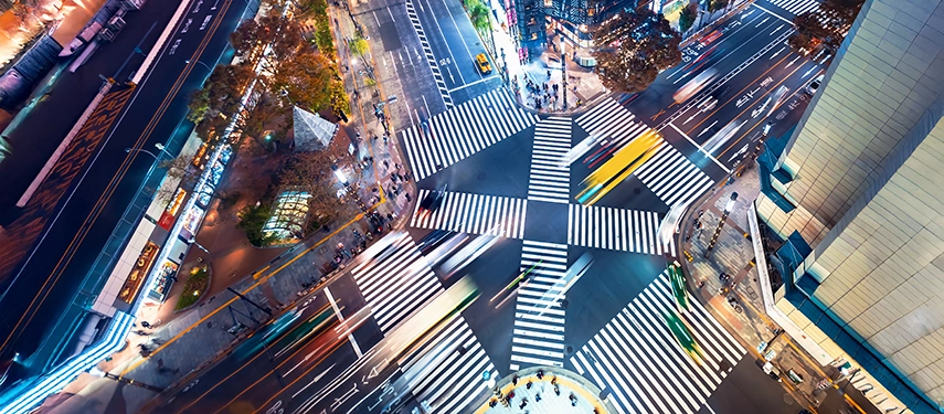 An aerial view of Tokyo’s iconic Shibuya Crossing at night, illustrating the dynamic energy of modern urban Japan.