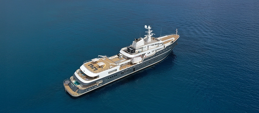 Aqua Lares cruising through calm tropical waters under clear blue skies.