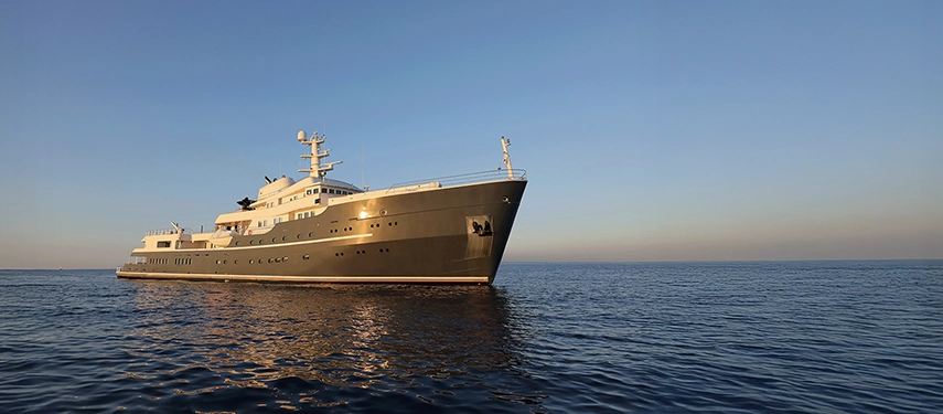 Aqua Lares cutting through serene ocean waters beneath a pastel evening sky.