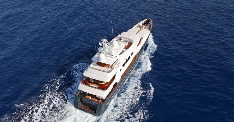 Aqua Mare superyacht cruising the deep blue waters of the Galápagos Islands under a clear equatorial sky.