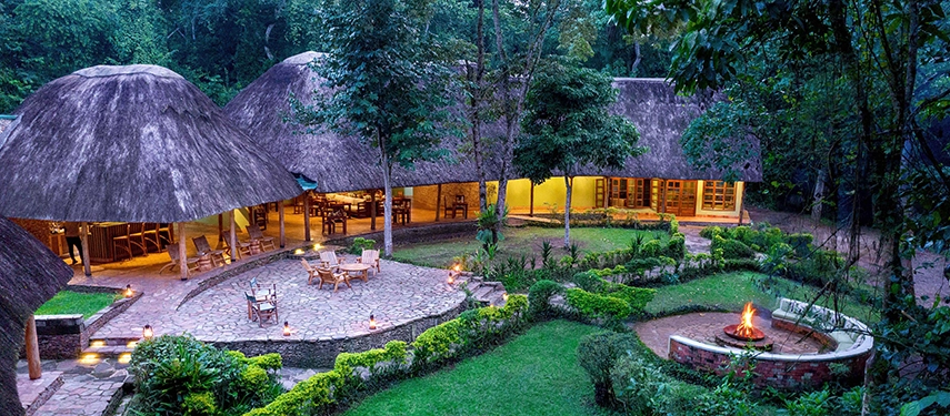 Panoramic aerial shot of Primate Lodge Kibale hidden within the lush Kibale National Park canopy.