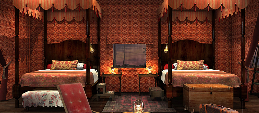 Twin four-poster beds with ornate safari decor inside a luxurious tent at Jack’s Private Camp.