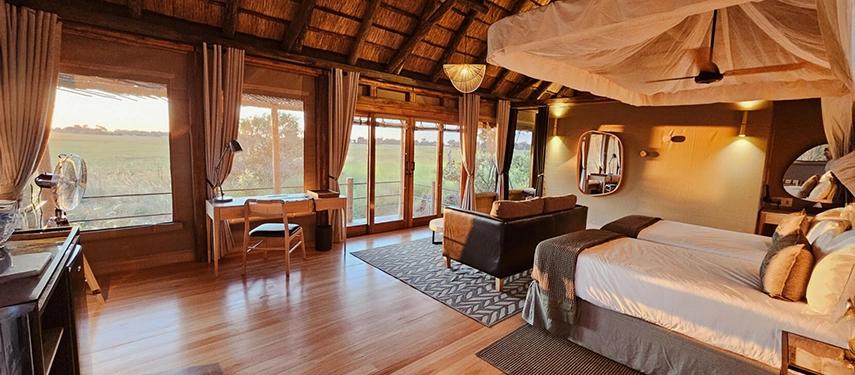 Elegant safari tent interior at Kanana Camp with views across the Okavango Delta floodplains.