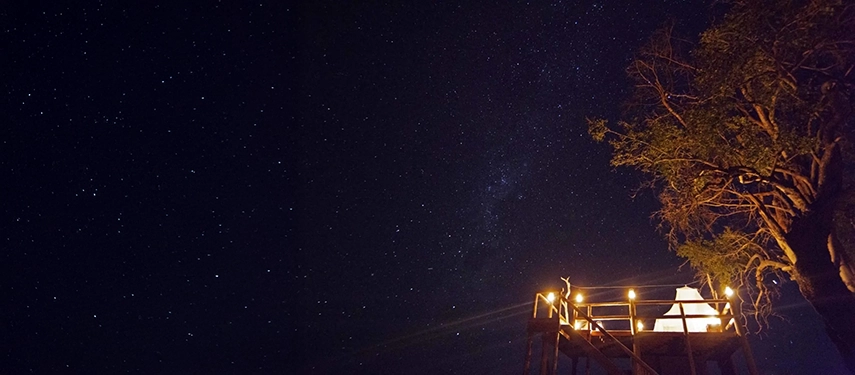 Elevated star bed platform glowing under a sky filled with stars near Kanana Camp.