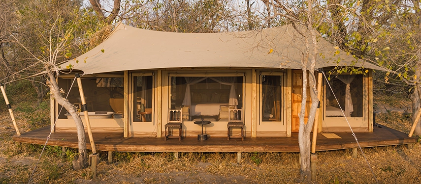 Front view of a luxury tent at Cha Cha Metsi with canvas canopy and wooden deck.