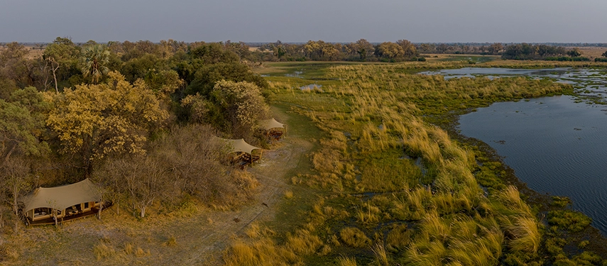 Aerial view of Cha Cha Metsi tents overlooking the Okavango Delta floodplains.