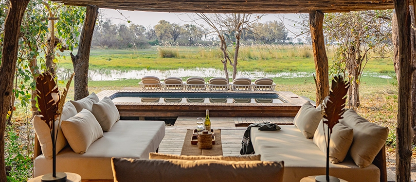 Poolside relaxation area with deck chairs and open Delta views at Cha Cha Metsi.