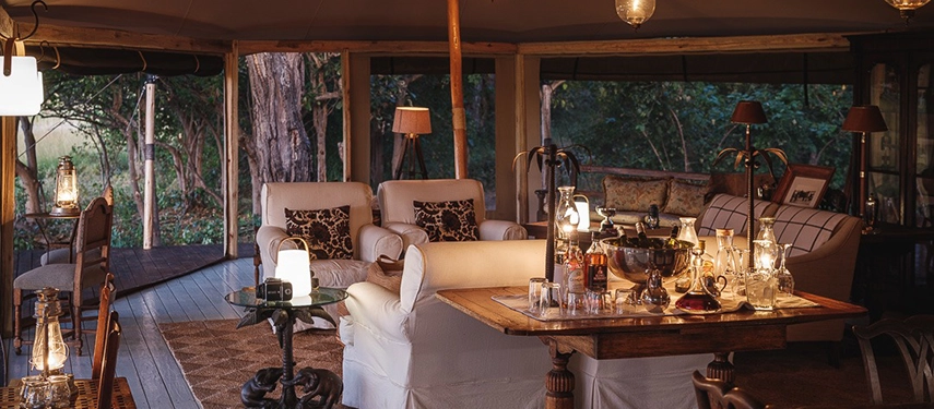 Main lounge at Cha Cha Metsi with lanterns and classic safari furnishings.