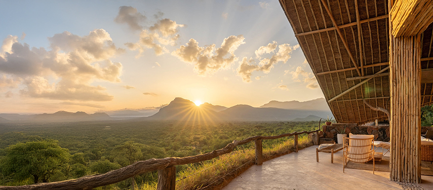 Spacious open-plan family suite with earthy tones and wide views into Samburu bushland.