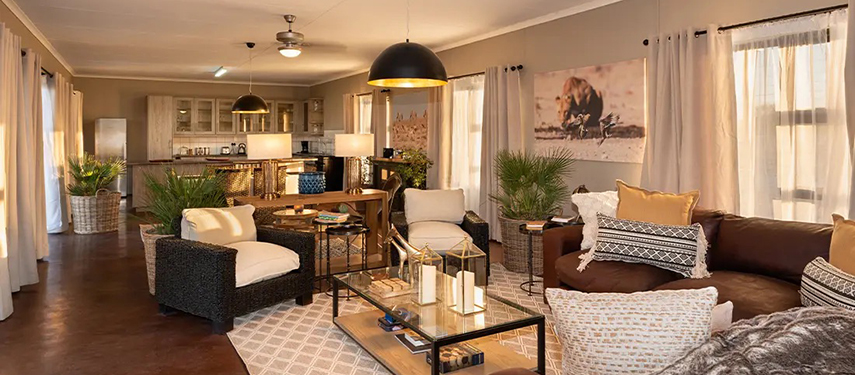 Stylish open-plan lounge and dining area at Safari House with comfortable modern decor.