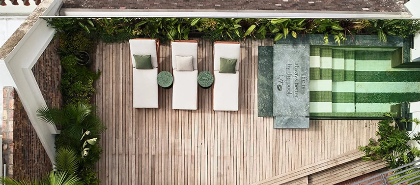 Aerial view of the rooftop pool deck and lounge chairs at Gorgeous George.