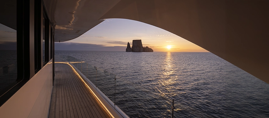 Elegant interior hallway with warm lighting aboard the Hermes Galápagos Mega Catamaran.