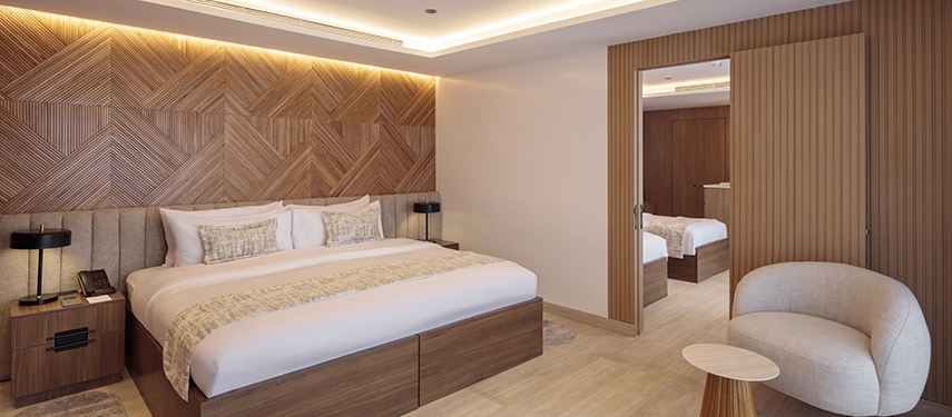 Spacious interconnected suite with modern wooden design on the Hermes Galápagos Mega Catamaran.