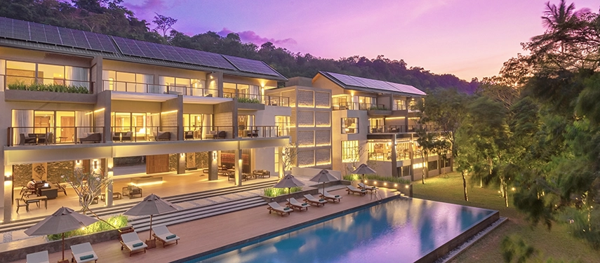 Jetwing Kandy Resort with a pool in front, lit by the violet hues of sunset